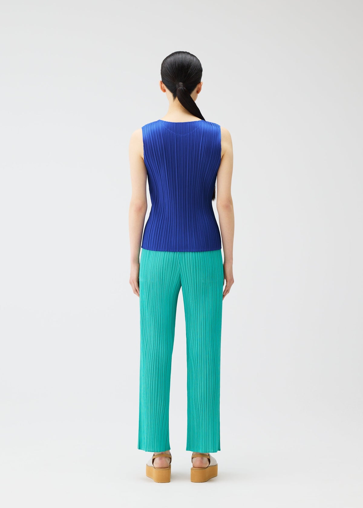 A model wears the PLEATS PLEASE ISSEY MIYAKE MONTHLY COLORS MAY top.