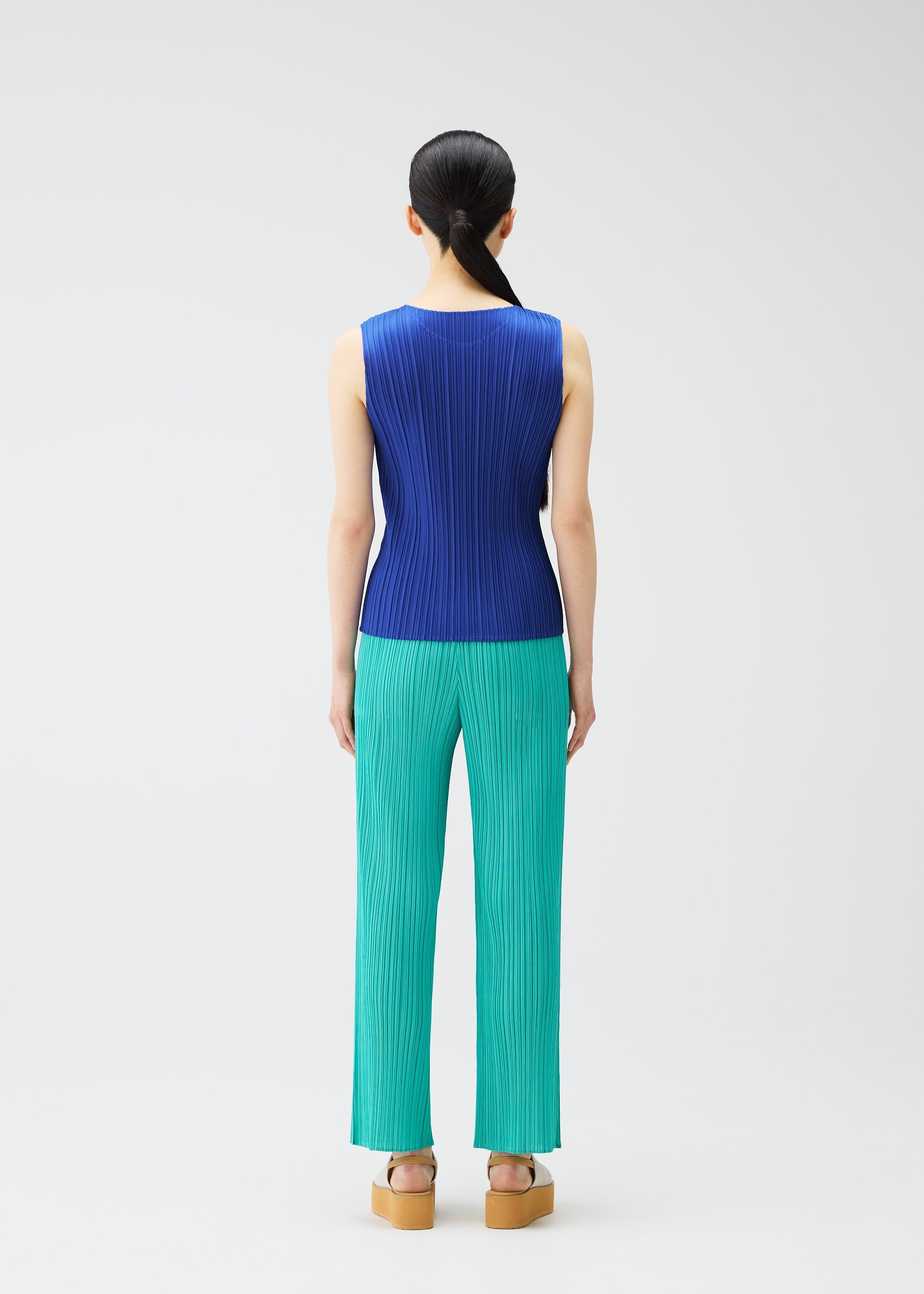 A model wears the PLEATS PLEASE ISSEY MIYAKE MONTHLY COLORS MAY top.