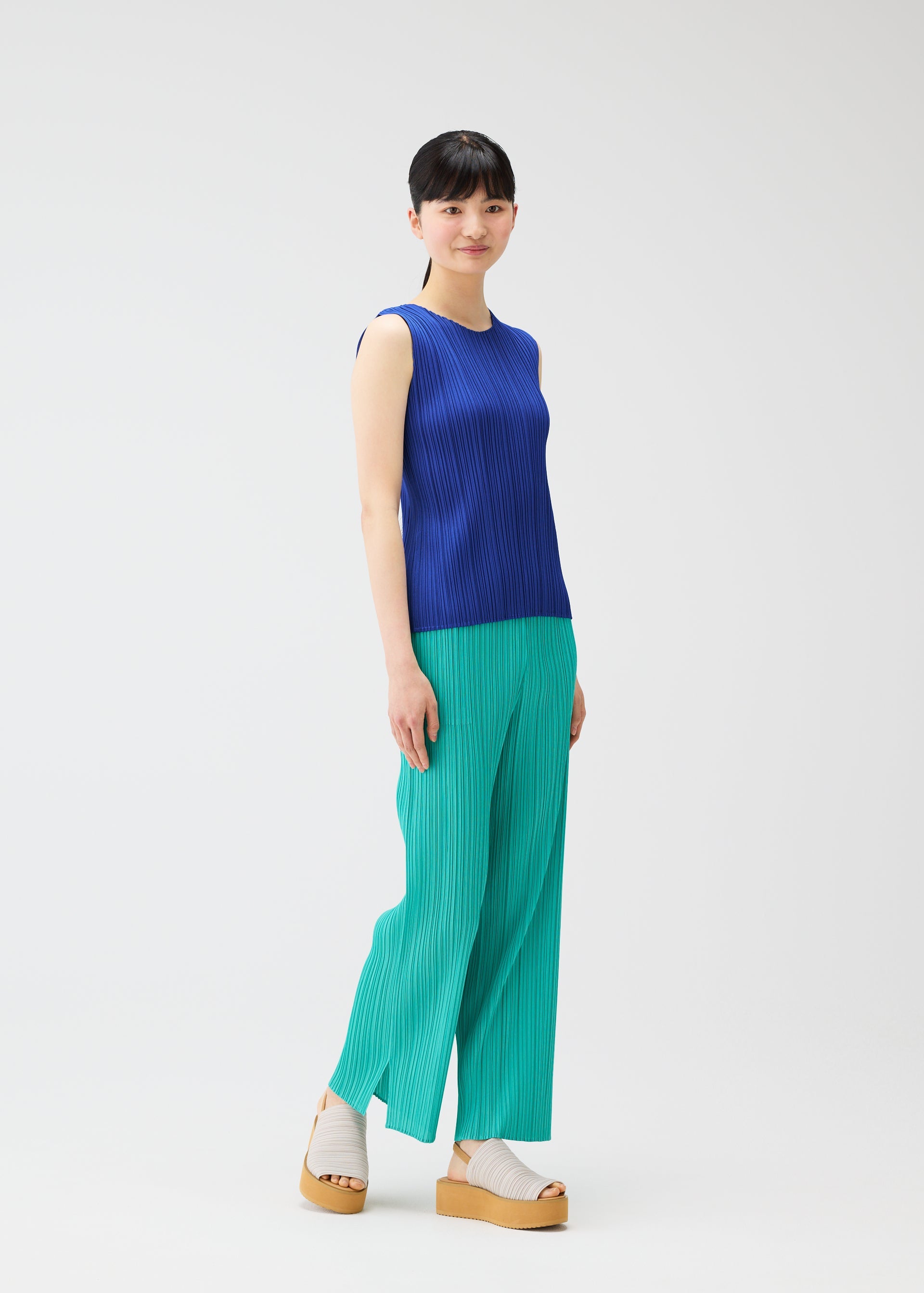 A model wears the PLEATS PLEASE ISSEY MIYAKE MONTHLY COLORS MAY top.