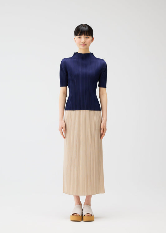A model wears the PLEATS PLEASE ISSEY MIYAKE MONTHLY COLORS MAY top.