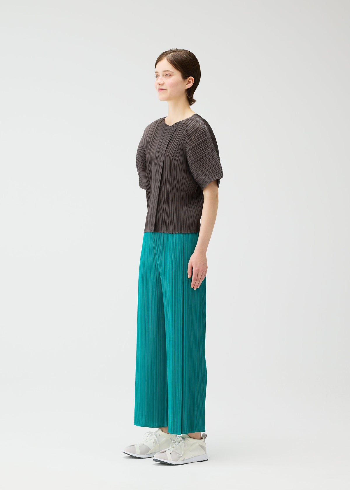 A model wears the PLEATS PLEASE ISSEY MIYAKE MONTHLY COLORS : JUNE monthly-colors-june-shirt-blue-green-1.