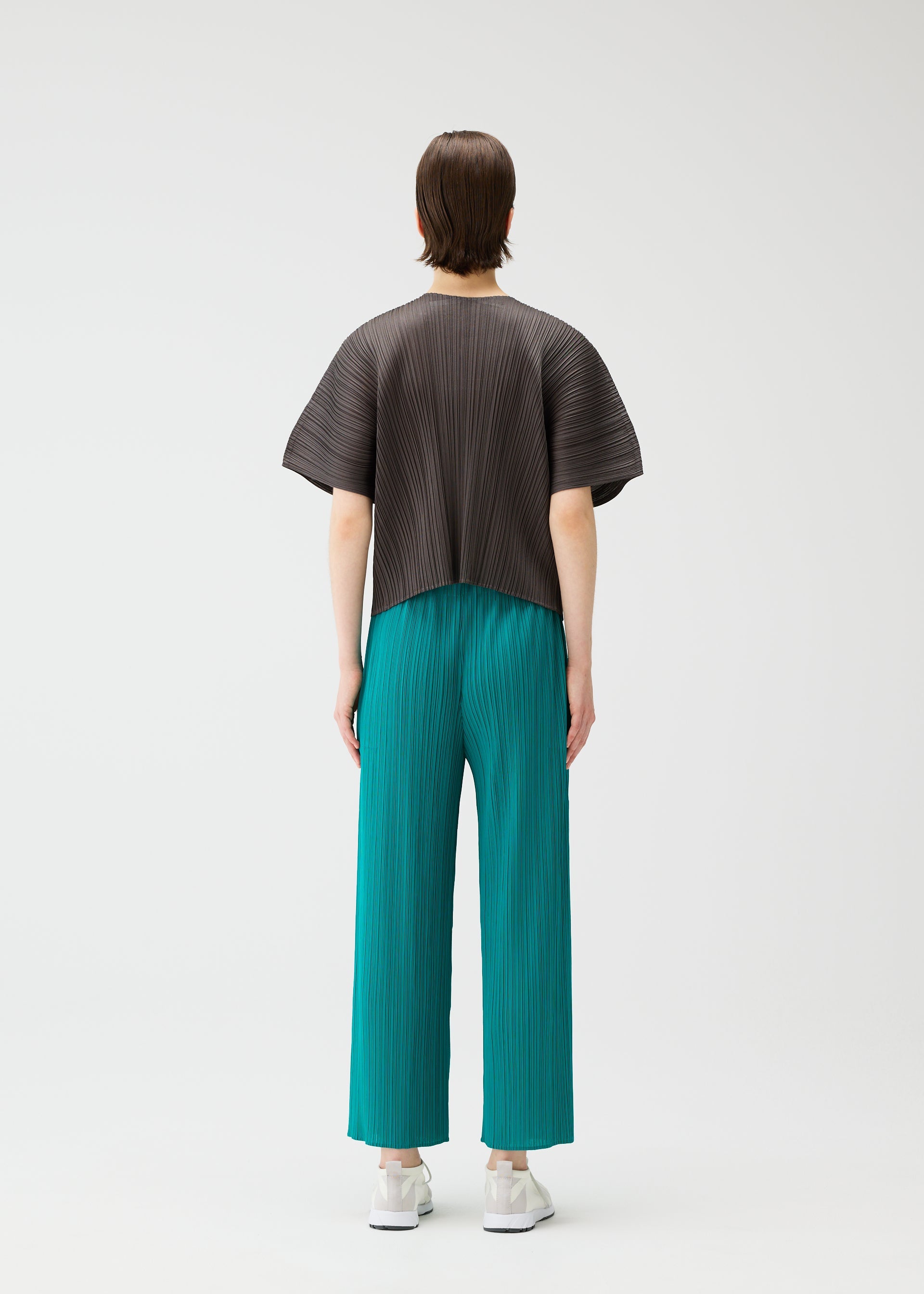 A model wears the PLEATS PLEASE ISSEY MIYAKE MONTHLY COLORS : JUNE monthly-colors-june-shirt-blue-green-1.