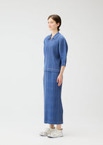 A model wears the PLEATS PLEASE ISSEY MIYAKE COTTON DENIM top.