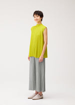 A model wears the PLEATS PLEASE ISSEY MIYAKE MELLOW PLEATS shirt.