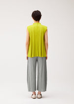 A model wears the PLEATS PLEASE ISSEY MIYAKE MELLOW PLEATS shirt.