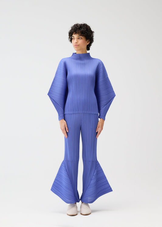 A model wears the PLEATS PLEASE ISSEY MIYAKE SKYLINE clothing.