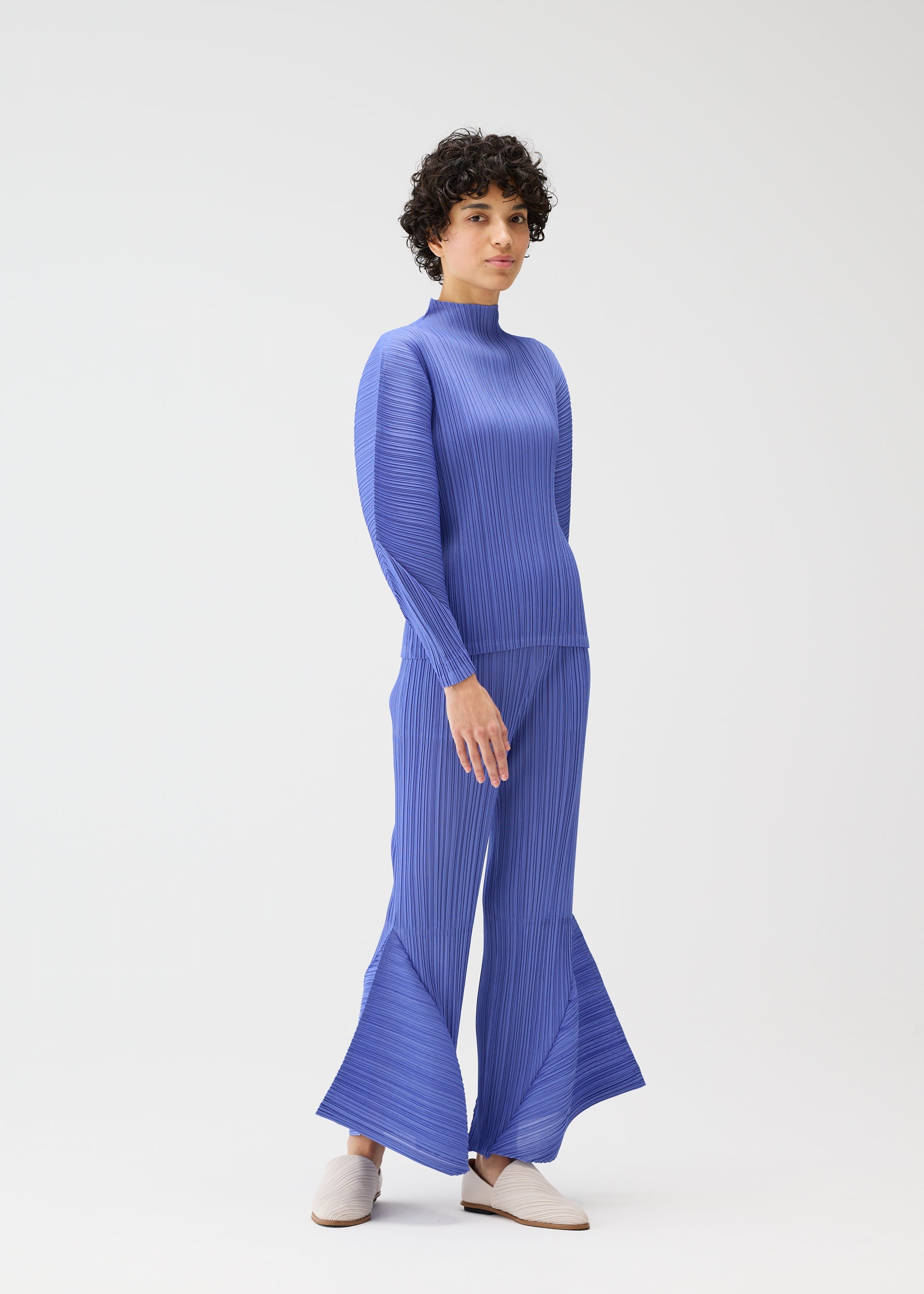 A model wears the PLEATS PLEASE ISSEY MIYAKE SKYLINE clothing.