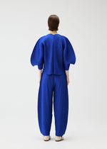 A model wears the PLEATS PLEASE ISSEY MIYAKE COAST shirt.