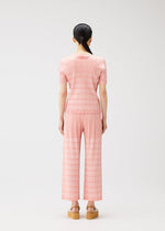 A model wears the PLEATS PLEASE ISSEY MIYAKE BUMPY BASKET bumpy-basket-shirt-green.
