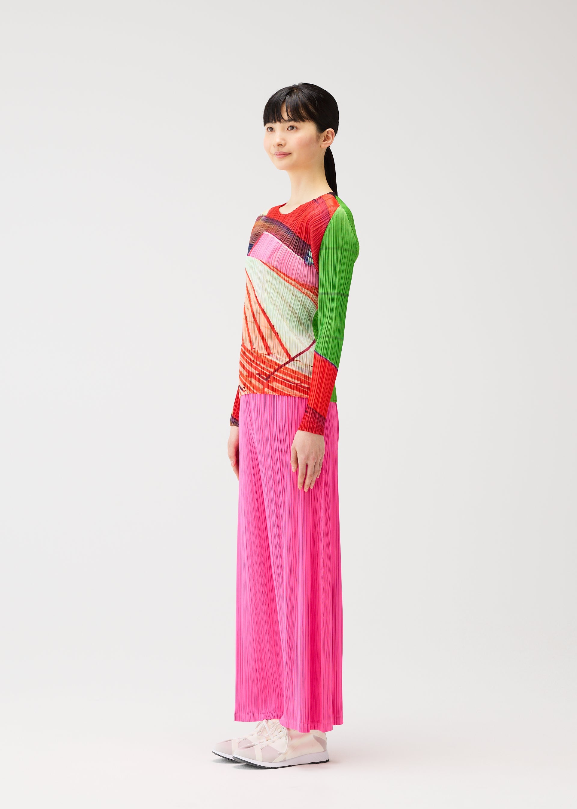 A model wears the PLEATS PLEASE ISSEY MIYAKE CITY COLLAGE clothing.