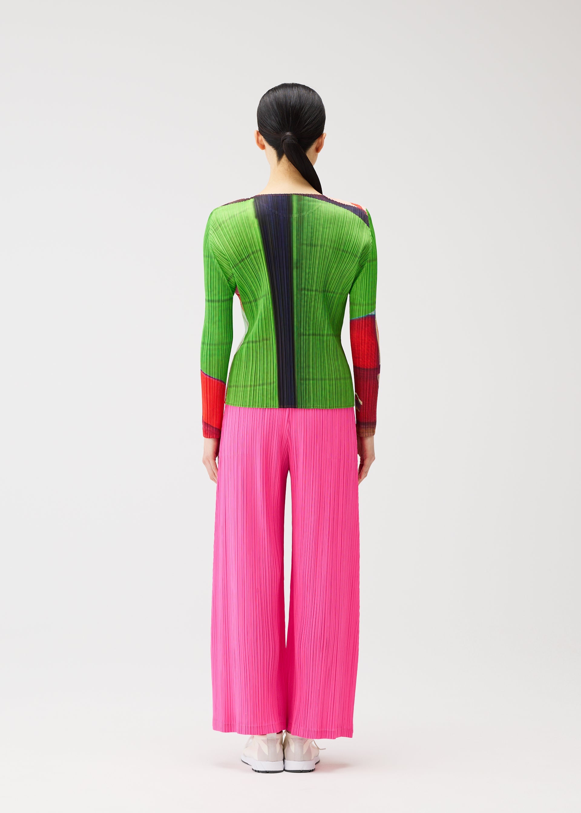 A model wears the PLEATS PLEASE ISSEY MIYAKE CITY COLLAGE clothing.