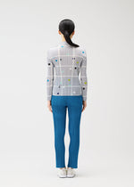 A model wears the PLEATS PLEASE ISSEY MIYAKE CROSSING DOTS shirt.