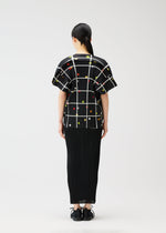 A model wears the PLEATS PLEASE ISSEY MIYAKE CROSSING DOTS shirt.