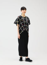 A model wears the PLEATS PLEASE ISSEY MIYAKE CROSSING DOTS shirt.