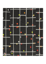 A detail shot of the PLEATS PLEASE ISSEY MIYAKE CROSSING DOTS shirt.