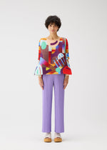 A model wears the PLEATS PLEASE ISSEY MIYAKE PLAYGROUND shirt.
