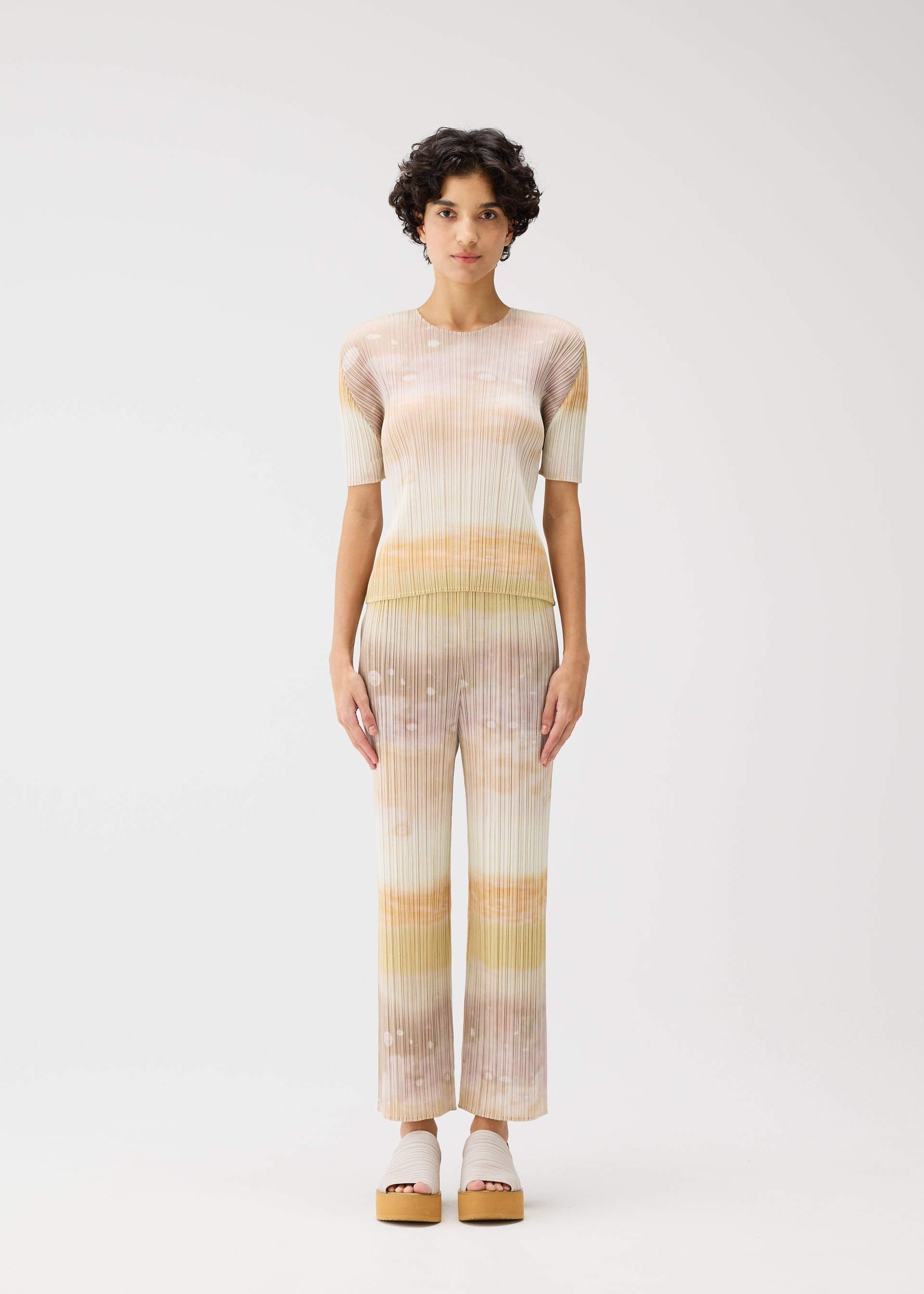 A model wears the PLEATS PLEASE ISSEY MIYAKE SEA BUBBLE top.