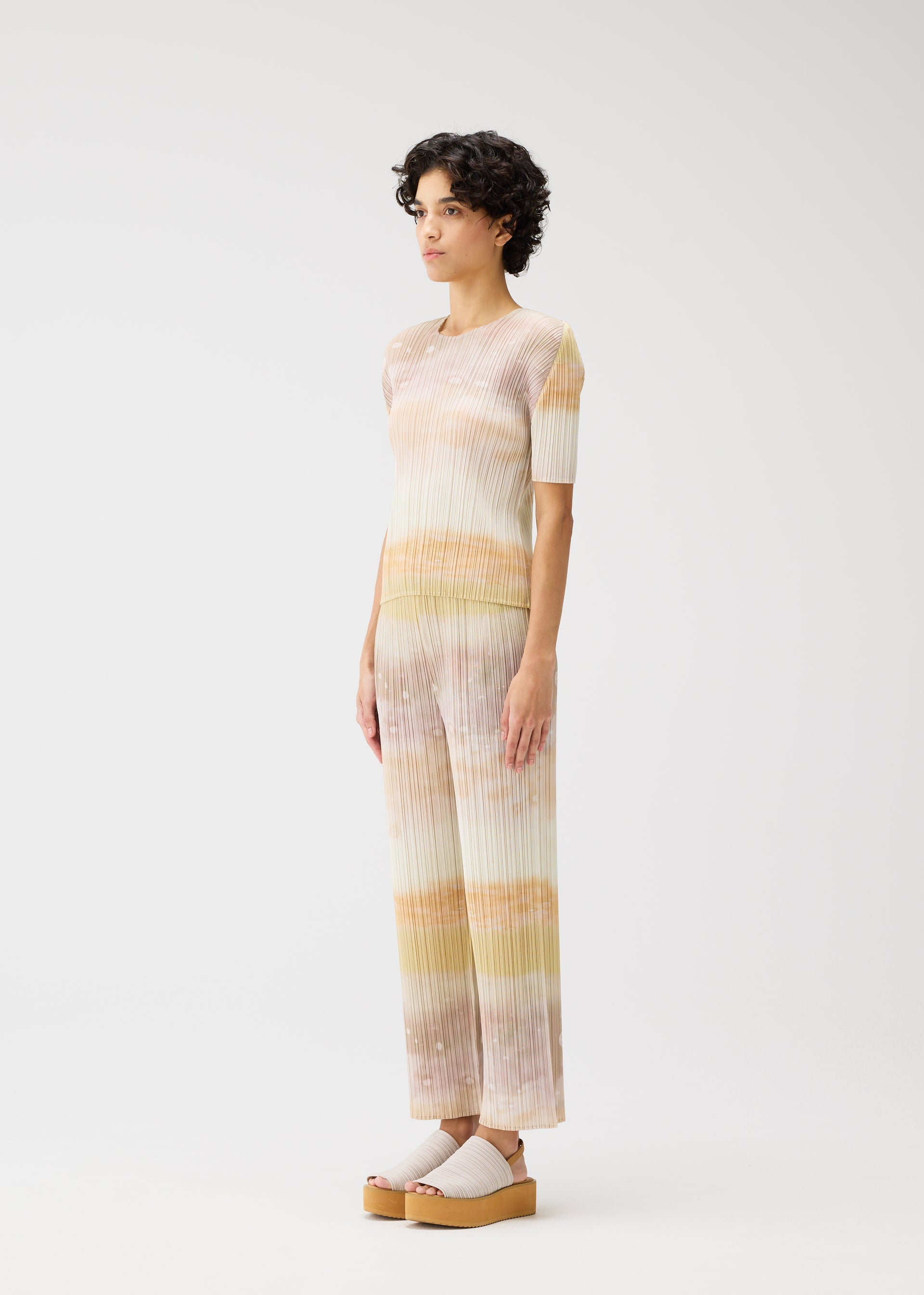 A model wears the PLEATS PLEASE ISSEY MIYAKE SEA BUBBLE top.