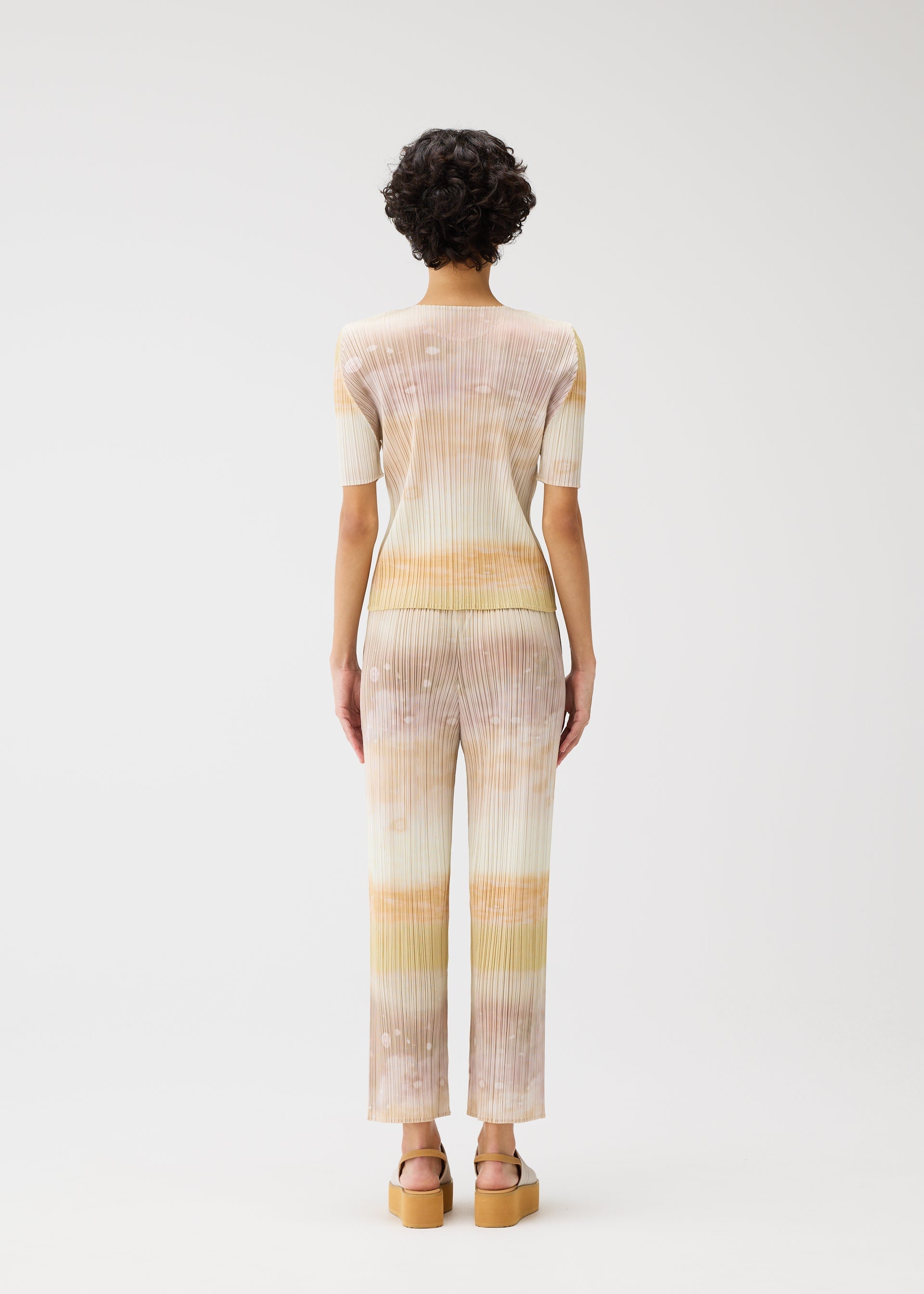 A model wears the PLEATS PLEASE ISSEY MIYAKE SEA BUBBLE top.
