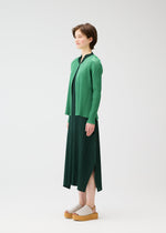 A model wears the PLEATS PLEASE ISSEY MIYAKE MONTHLY COLORS MARCH cardigan.