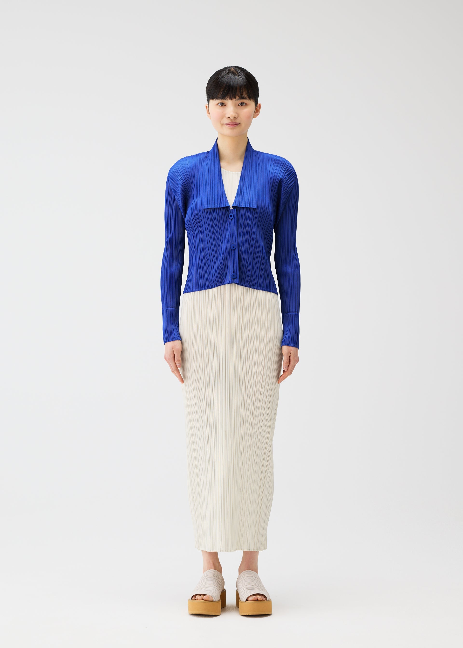 A model wears the PLEATS PLEASE ISSEY MIYAKE MONTHLY COLORS MAY cardigan.