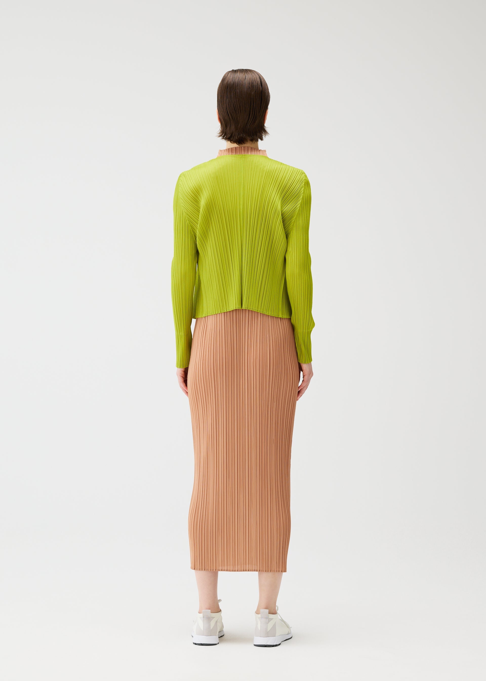 A model wears the PLEATS PLEASE ISSEY MIYAKE MONTHLY COLORS : JUNE monthly-colors-june-cardigan-yellow-green.