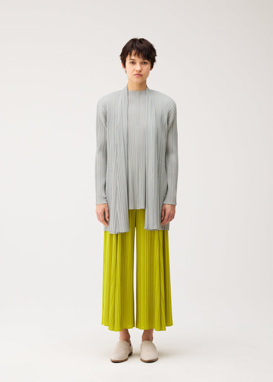 A model wears the PLEATS PLEASE ISSEY MIYAKE MELLOW PLEATS cardigan.
