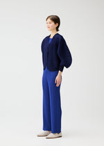 A model wears the PLEATS PLEASE ISSEY MIYAKE COAST cardigan.