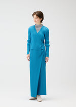 A model wears the PLEATS PLEASE ISSEY MIYAKE FACADE cardigan.