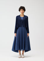 A model wears the PLEATS PLEASE ISSEY MIYAKE CITY FRAME cardigan.