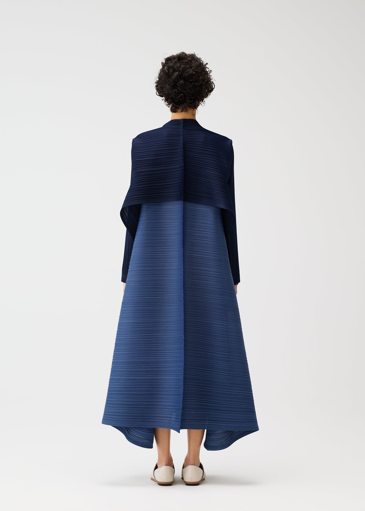 A model wears the PLEATS PLEASE ISSEY MIYAKE CITY FRAME cardigan.