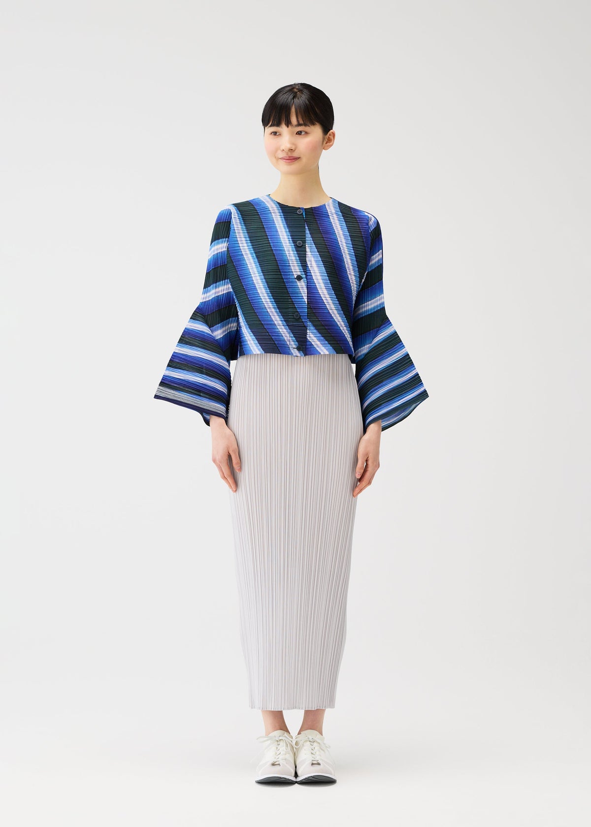 A model wears the PLEATS PLEASE ISSEY MIYAKE CITY COLLAGE clothing.