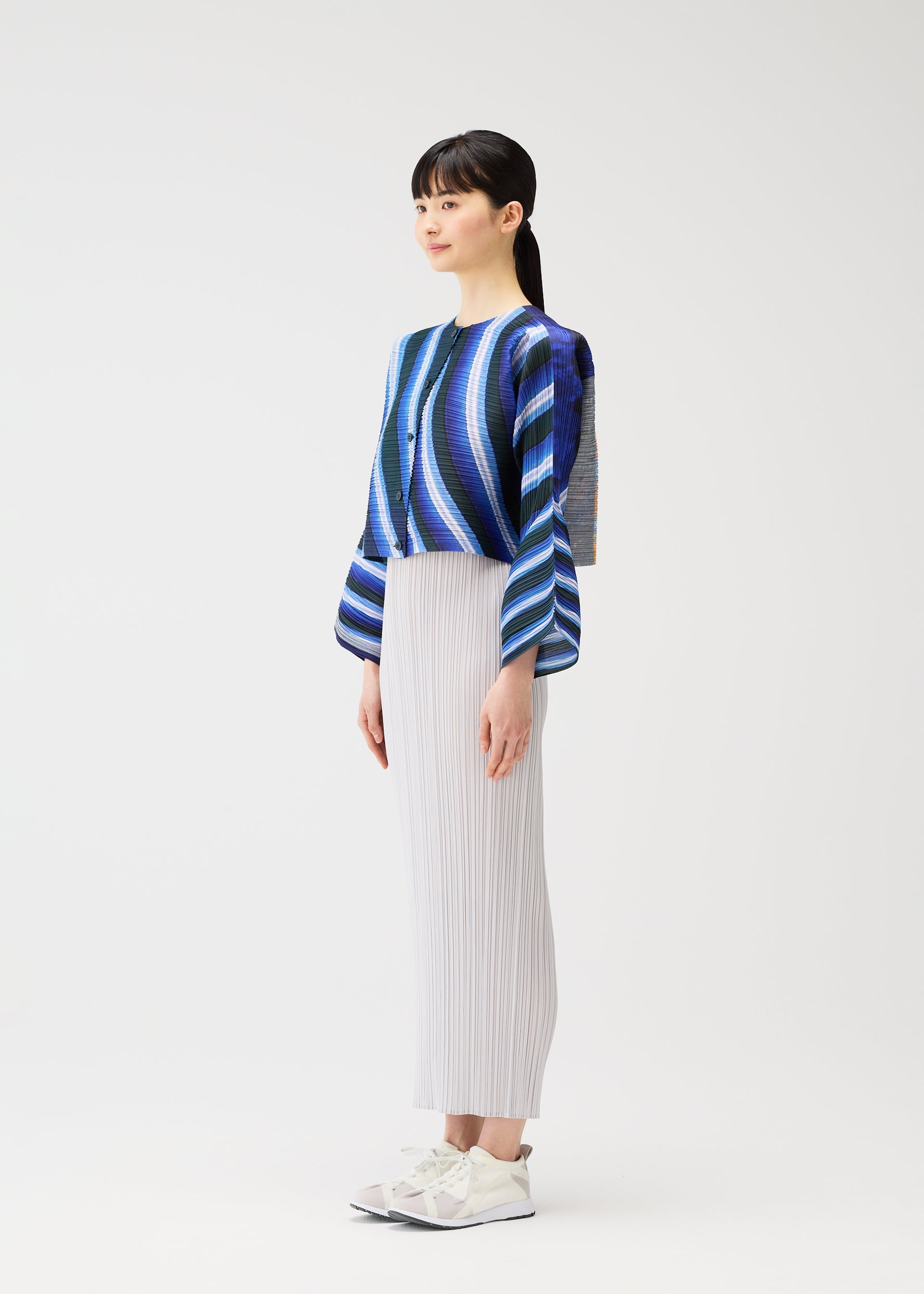 A model wears the PLEATS PLEASE ISSEY MIYAKE CITY COLLAGE clothing.