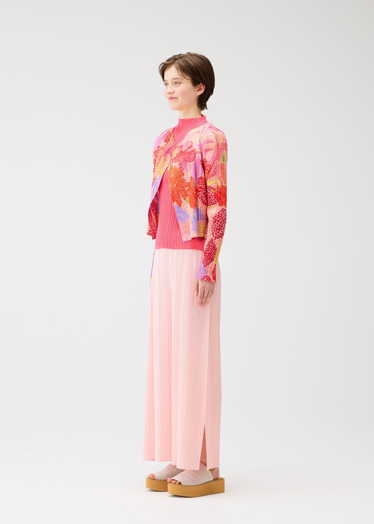 A model wears the PLEATS PLEASE ISSEY MIYAKE FOGGY FOREST cardigan.