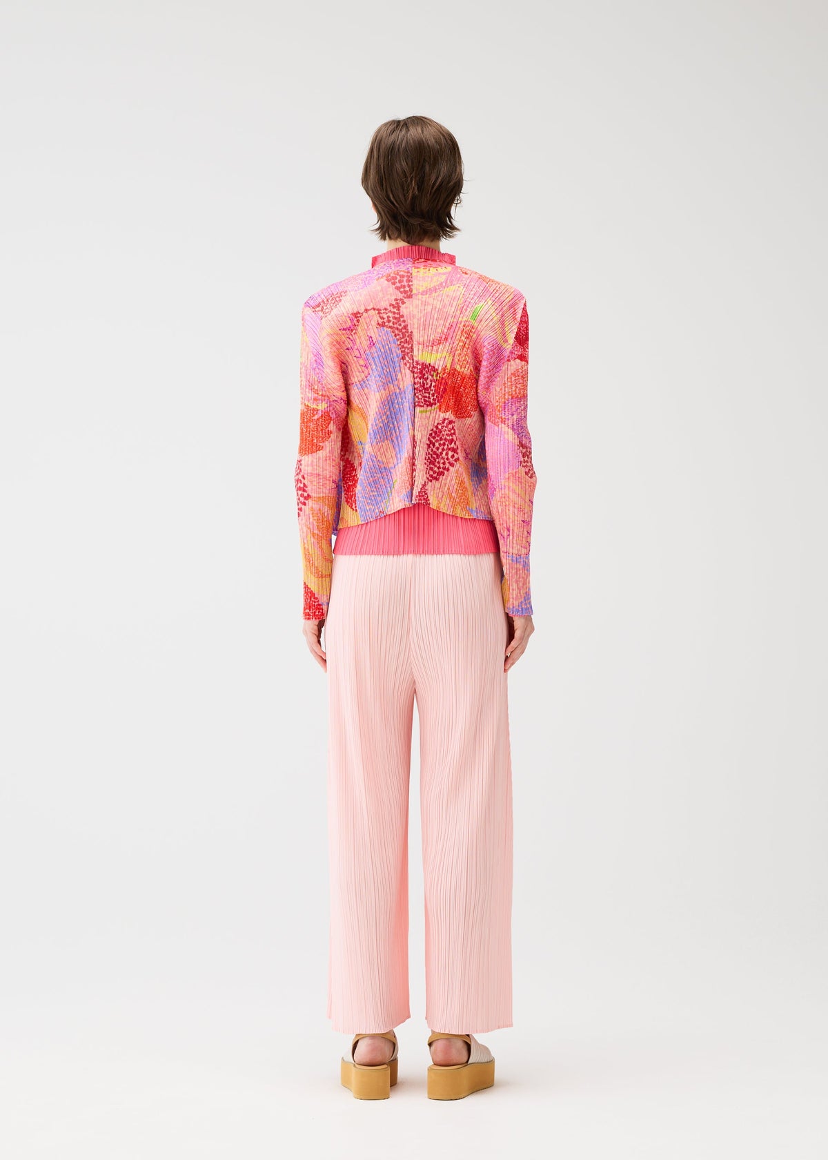 A model wears the PLEATS PLEASE ISSEY MIYAKE FOGGY FOREST cardigan.