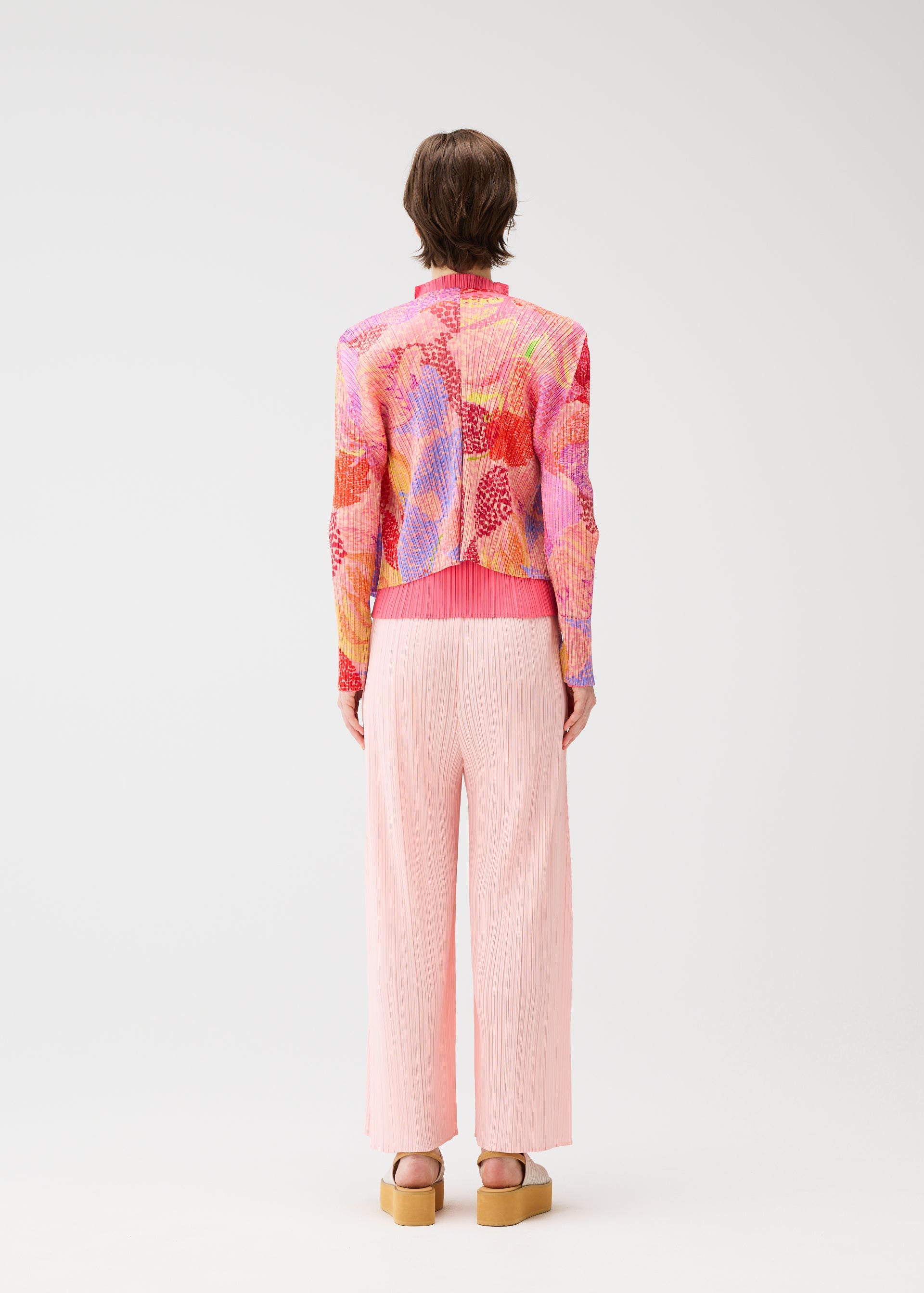 A model wears the PLEATS PLEASE ISSEY MIYAKE FOGGY FOREST cardigan.