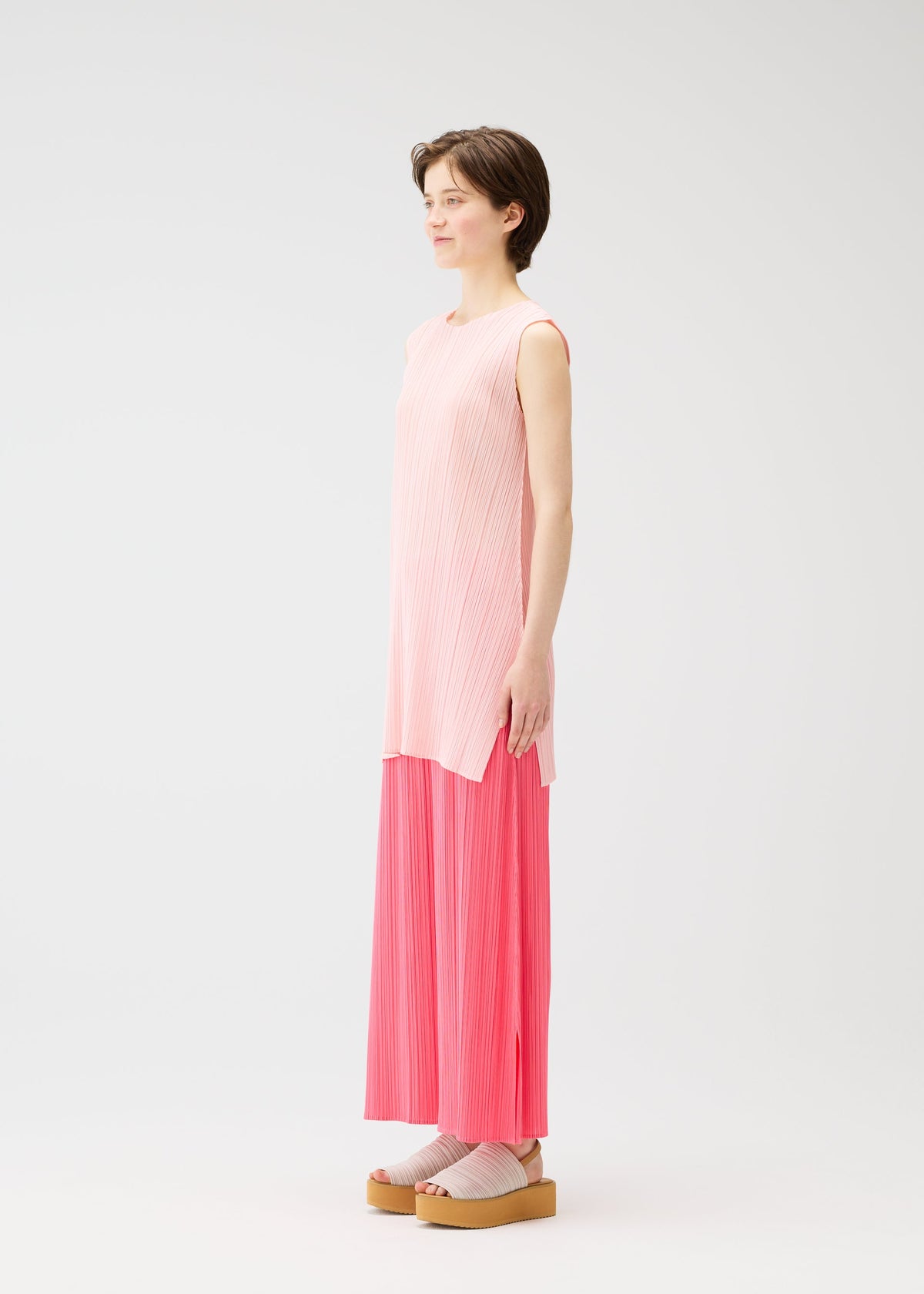 A model wears the PLEATS PLEASE ISSEY MIYAKE MONTHLY COLORS MARCH dress.