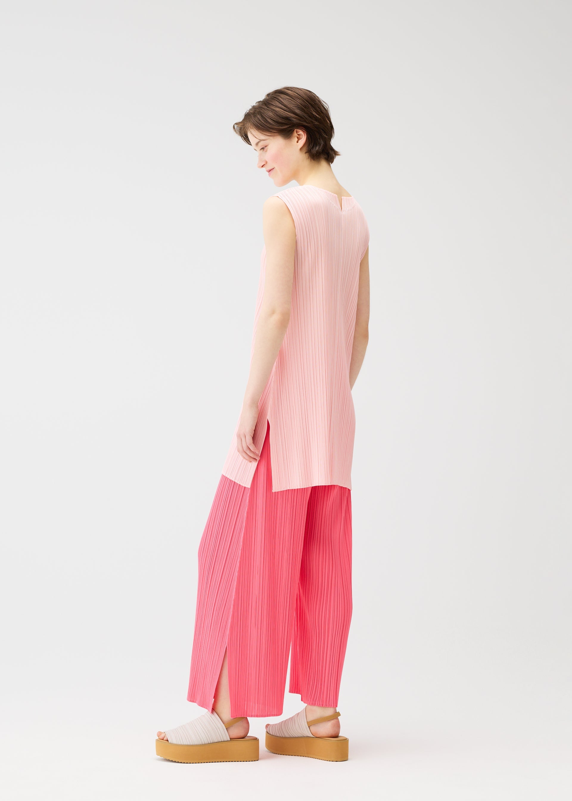 A model wears the PLEATS PLEASE ISSEY MIYAKE MONTHLY COLORS MARCH dress.