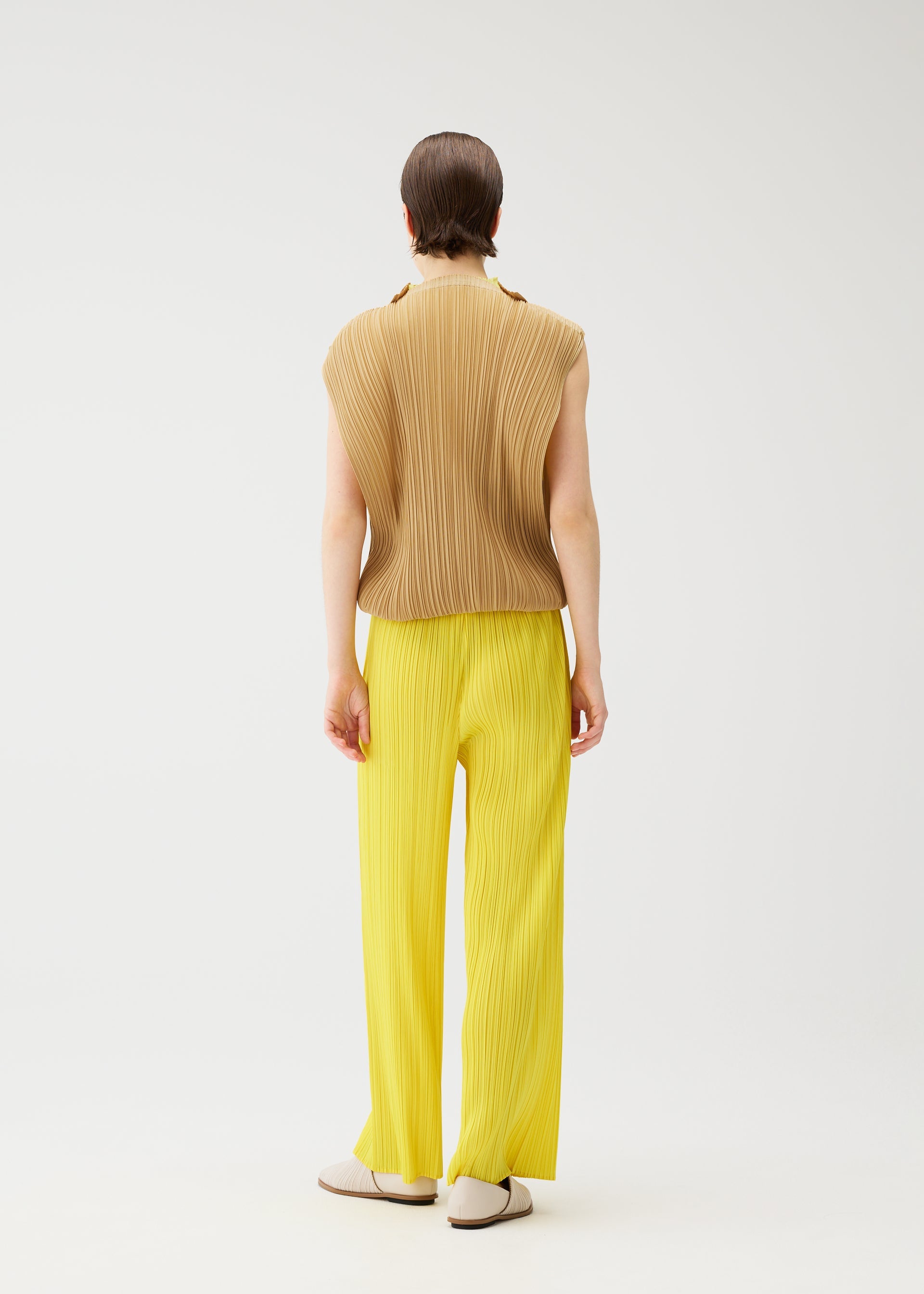 A model wears the PLEATS PLEASE ISSEY MIYAKE SWING dress.