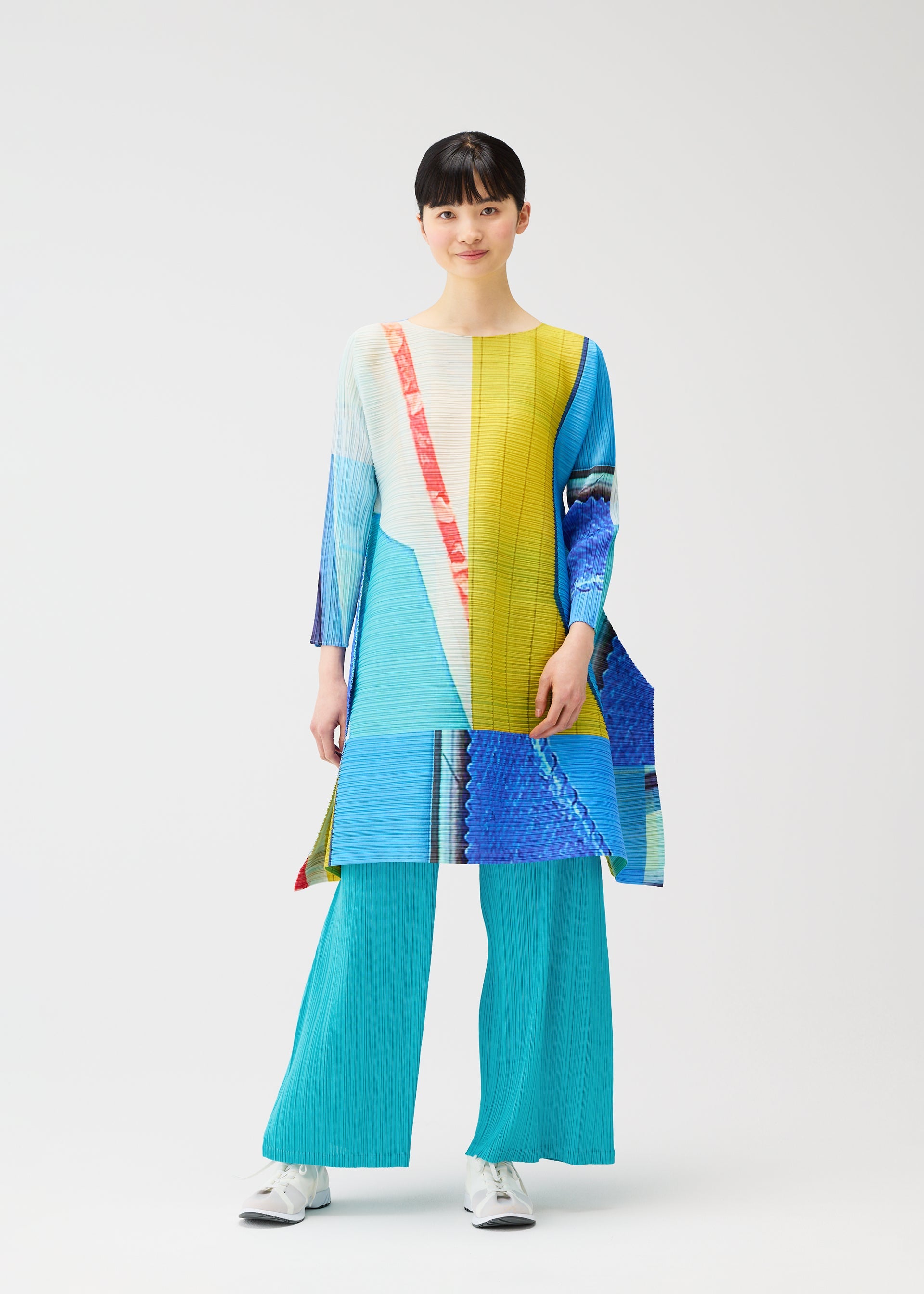A model wears the PLEATS PLEASE ISSEY MIYAKE CITY COLLAGE clothing.