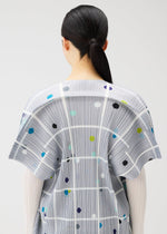 A model wears the PLEATS PLEASE ISSEY MIYAKE CROSSING DOTS dress.