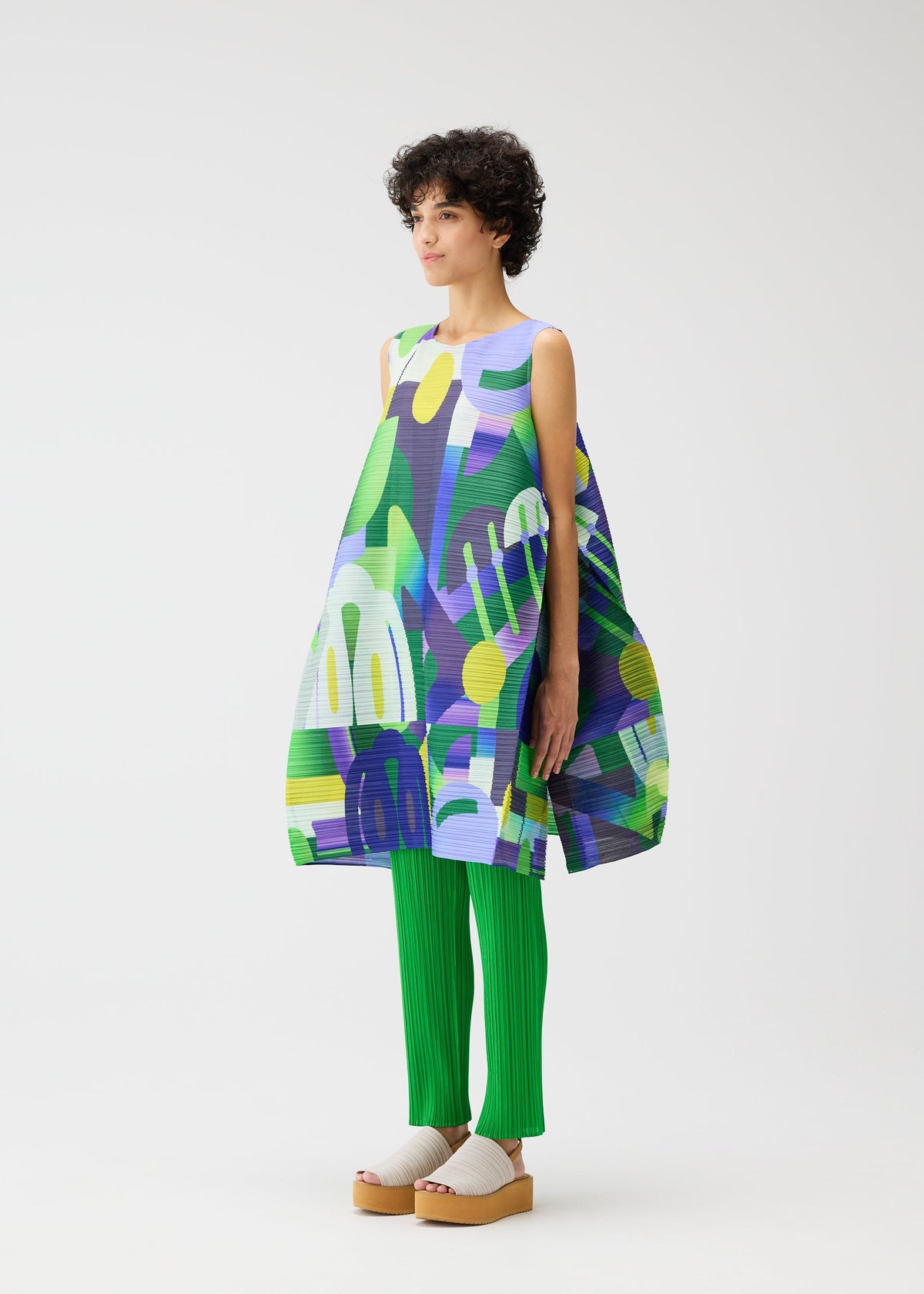A model wears the PLEATS PLEASE ISSEY MIYAKE PLAYGROUND dress.