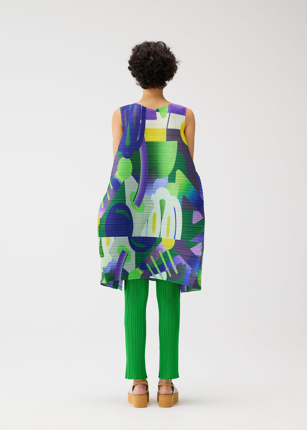 A model wears the PLEATS PLEASE ISSEY MIYAKE PLAYGROUND dress.