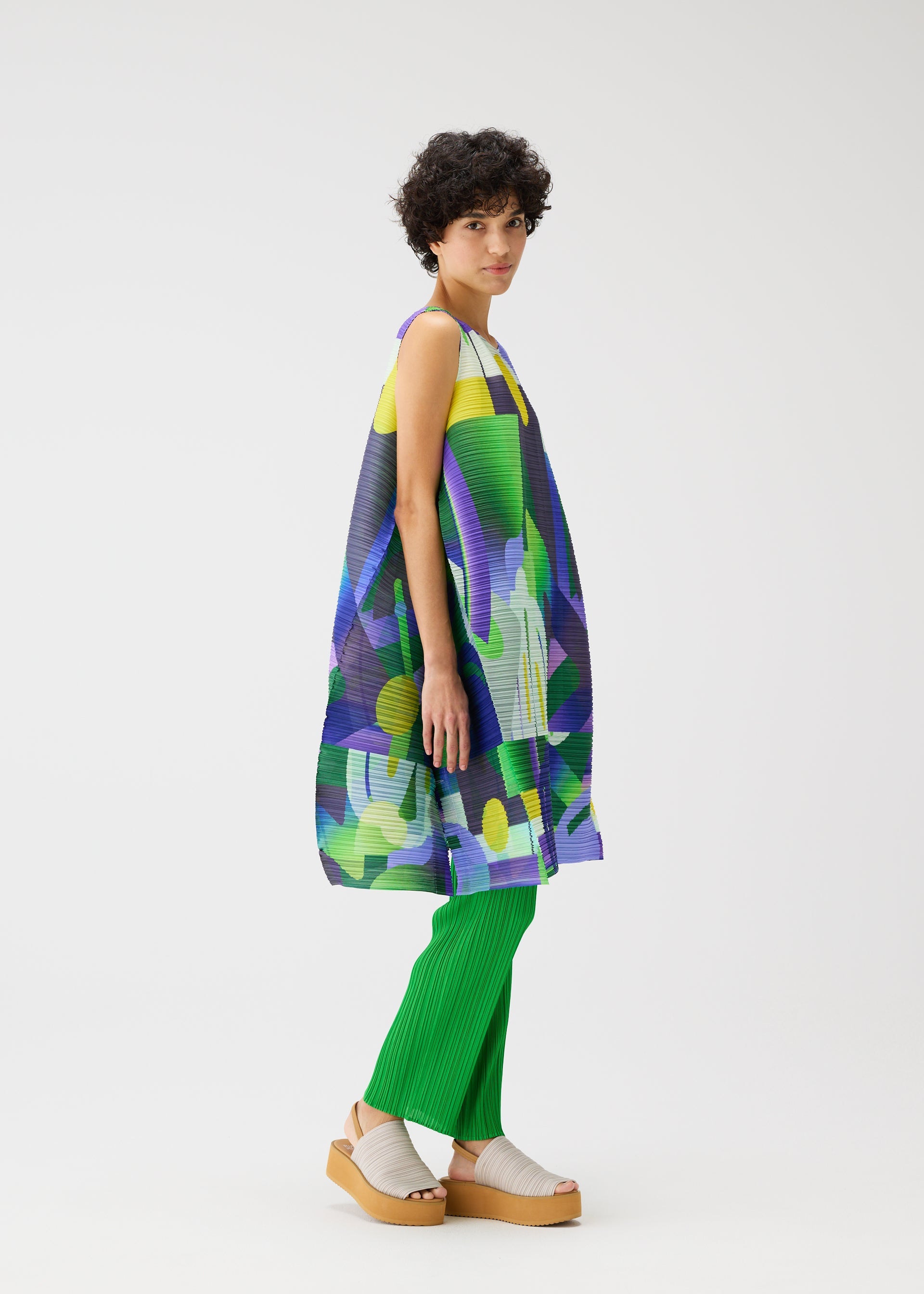 A model wears the PLEATS PLEASE ISSEY MIYAKE PLAYGROUND dress.
