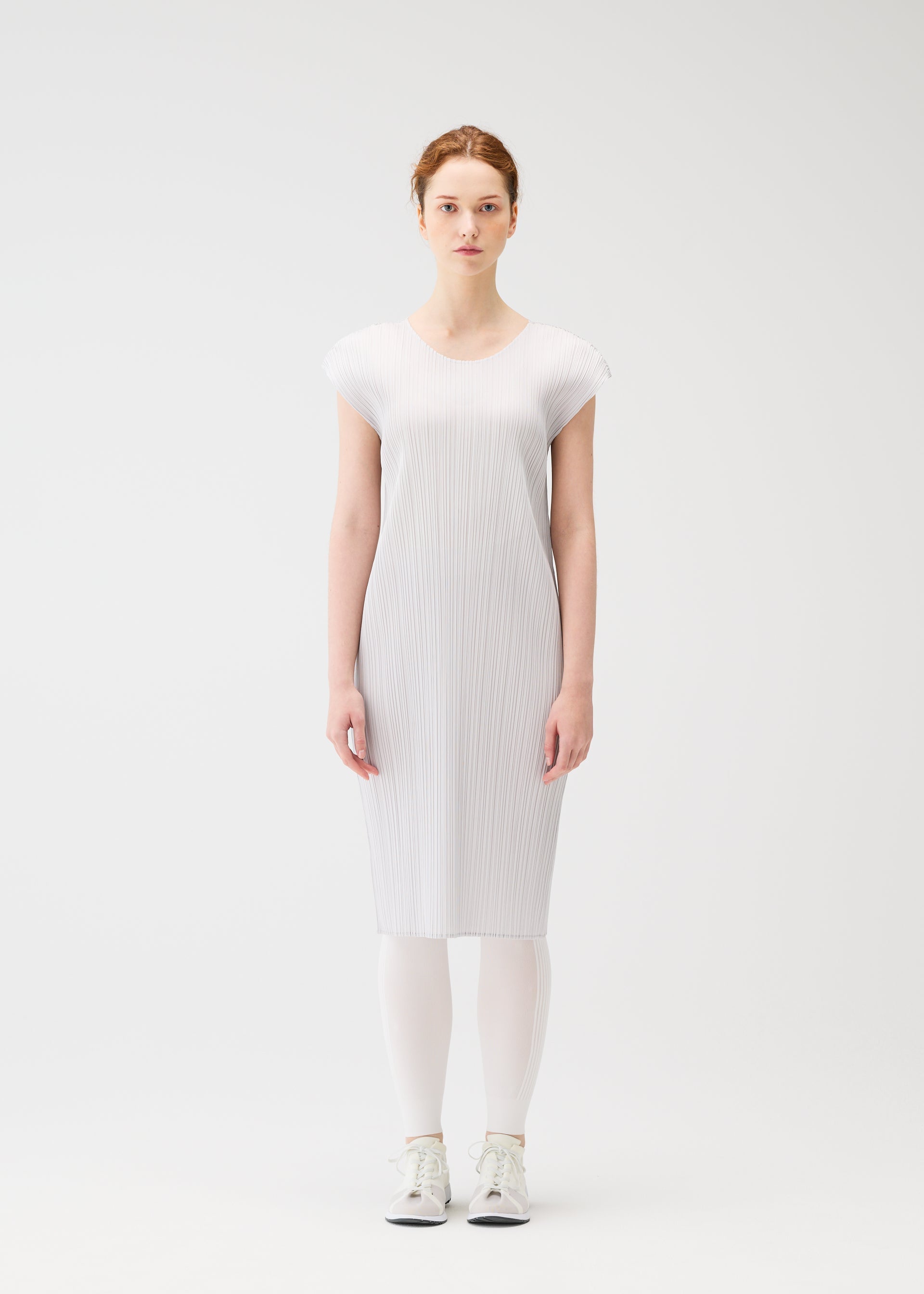 A model wears the PLEATS PLEASE ISSEY MIYAKE A POC SKIN trousers.