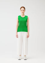 A model wears the PLEATS PLEASE ISSEY MIYAKE A POC BOTTOMS trousers.