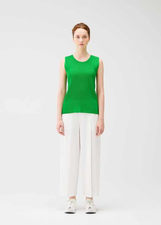 A model wears the PLEATS PLEASE ISSEY MIYAKE A POC BOTTOMS trousers.