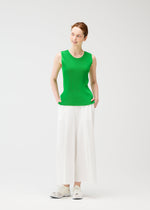 A model wears the PLEATS PLEASE ISSEY MIYAKE A POC BOTTOMS trousers.