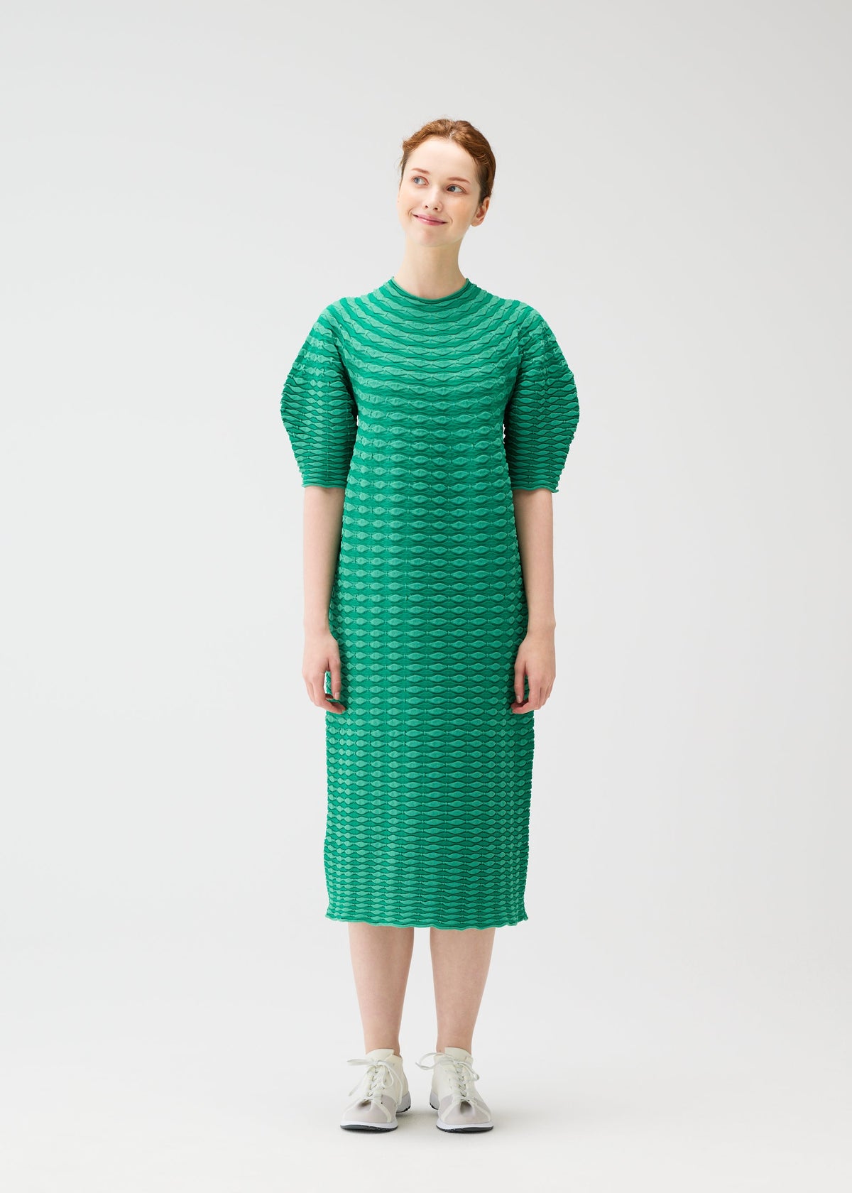 A model wears the PLEATS PLEASE ISSEY MIYAKE COLORFUL MUSHROOM KNIT dress.