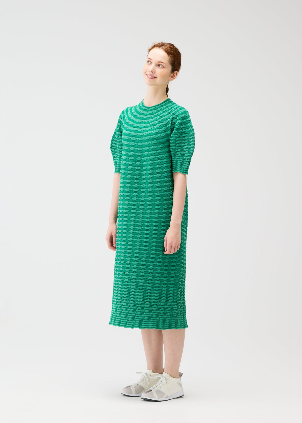 A model wears the PLEATS PLEASE ISSEY MIYAKE COLORFUL MUSHROOM KNIT dress.